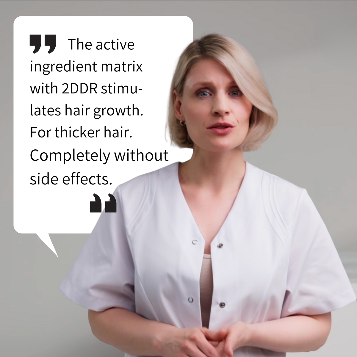 female medical professional wearing a white clinical coat speaking directly to camera, shown next to a speech bubble containing the text “The active ingredient matrix with 2DDR stimulates hair growth. For thicker hair. Completely without side effects.” The image visually supports ribogrow’s hair growth concept, highlighting the active ingredient matrix with 2-deoxy-D-ribose (2DDR) and its role in supporting thicker hair, presented in a clean, professional, and dermatology-inspired setting.