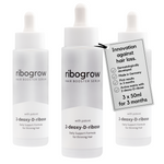 ribogrow® hair booster serum shown as a triple pack consisting of three frosted glass dropper bottles with white pipette caps. Each bottle is labeled “hair booster serum” and “with potent 2-deoxy-D-ribose,” described as a daily support formula for thinning hair. A product tag highlights innovation against hair loss, dermatologically developed formula, made in Germany, first visible results in 3 months, and an active matrix with 2-deoxy-D-ribose. The tag clearly states 3 x 50 ml